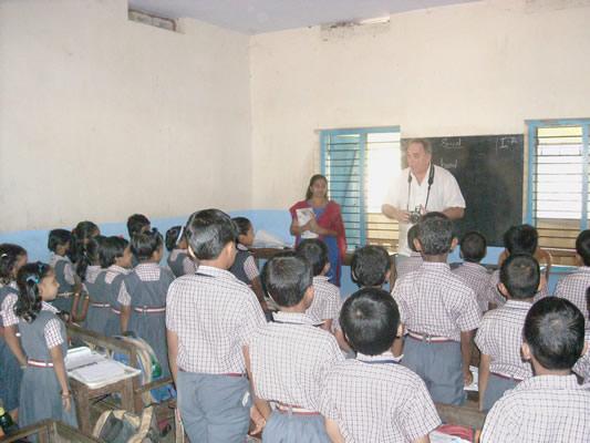 A visitor from the United States talks to students